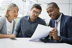 a life settlement provider signing a document with a couple