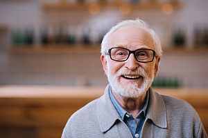 a senior man smiling after receiving a viatical life settlement